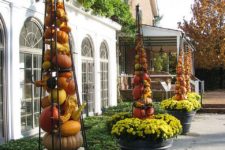 20 place yellow flower containers with tomato cages filled with gourds around your house