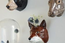 21 colorful faux animal heads to use as wall-mounted vases