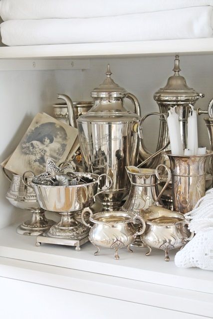 vintage silver collection arranged on shelf
