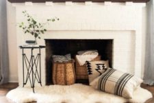 22 cozy up your fireplace with pillows, baskets and blankets