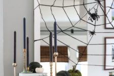 22 modern Halloween mantle with its spider web mirror, ravens and gold candle sticks