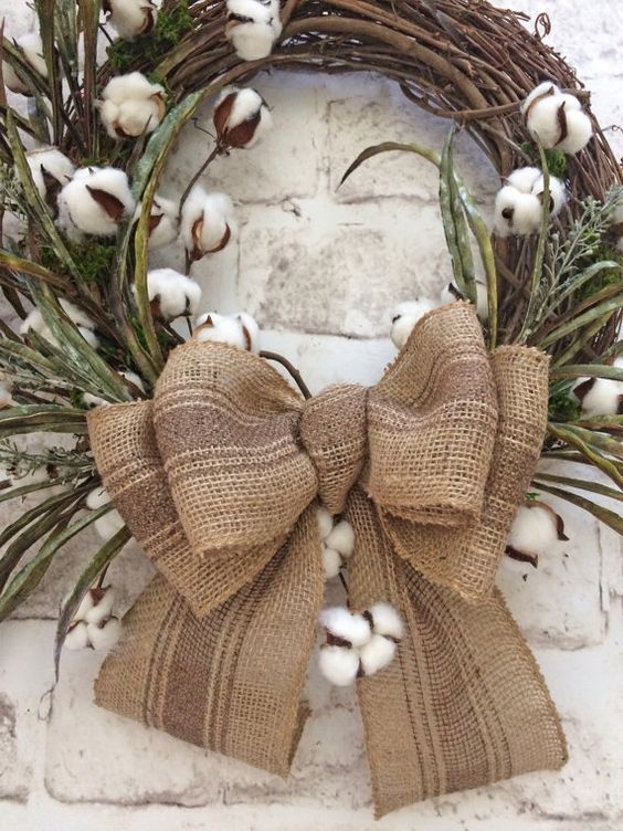 simple cotton wreath with a large burlap bow
