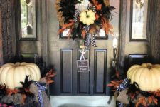 24 elegant Halloween decor with black and orange feathers and white pumpkins