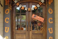 26 not spooky Halloween door decor in orange and black