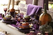 bold purple table setting with pumpkins and leaves