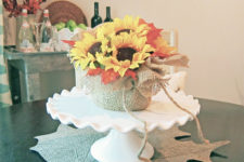 DIY fall centerpiece with burlap and faux flowers and leaves