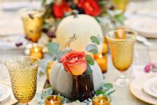 fresh flowers and eucalyptus with a lot of votives bring a festive touch