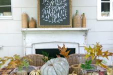 plaid tablecloth, pumpkins, leaves and gourds with black chargers
