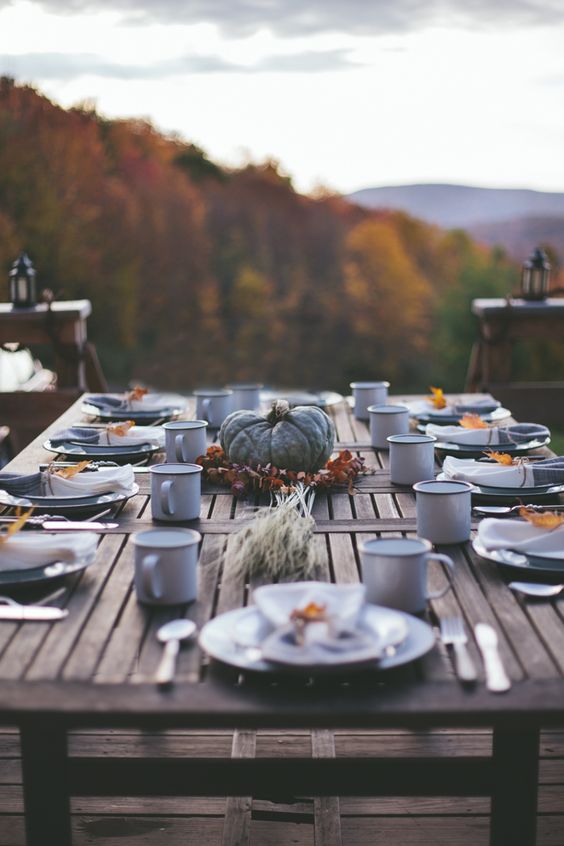 simple outdoor table with a pumpkin centerpiece and leaf napkin rings
