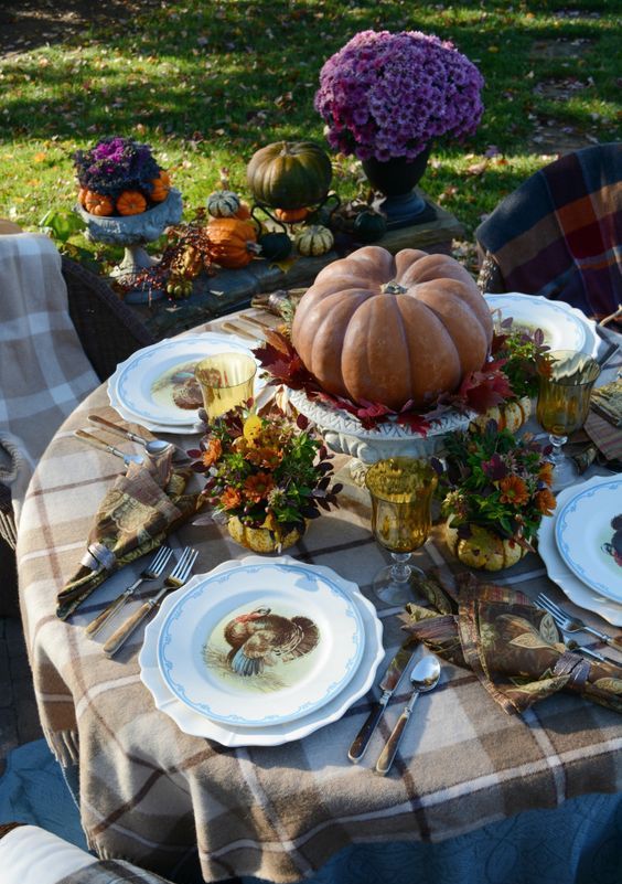 traditional table decor with a large pumpkin and fall flowers