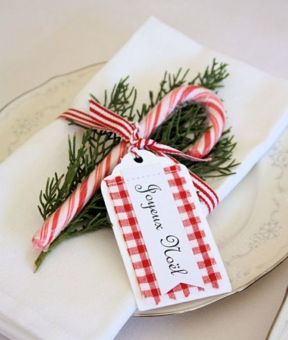 a candy cane favor with a gift tag for each place setting