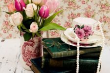 02 a stack of books, tulips in a vase, a vintage tea cup with pearls
