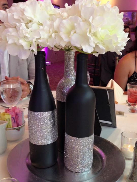 black chalkboard paint and silver glitter centerpieces made from wine bottles