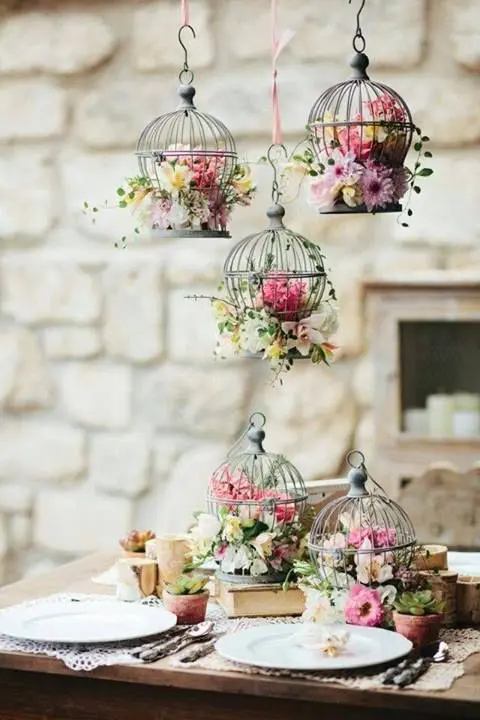 bird mini cages with flowers as centerpieces and hanging decor
