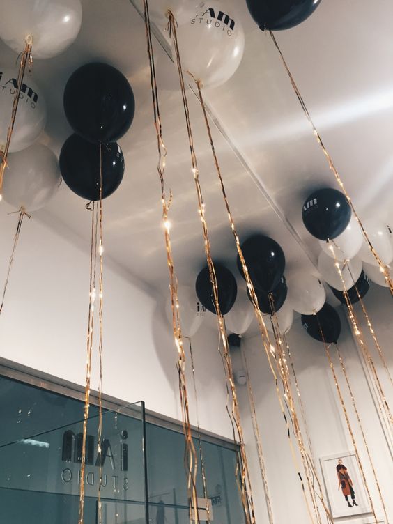 black and white balloons with golden tassels