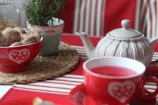 06 decorate the holiday tea table in red and white, add cozies and cable knit coasters