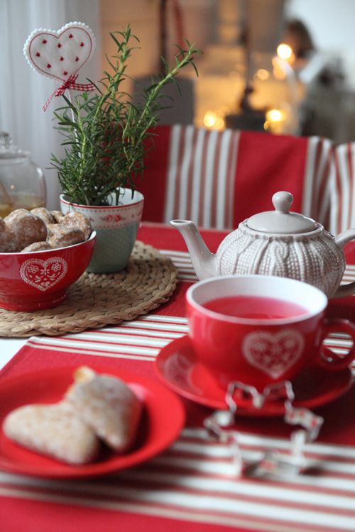 decorate the holiday tea table in red and white, add cozies and cable knit coasters
