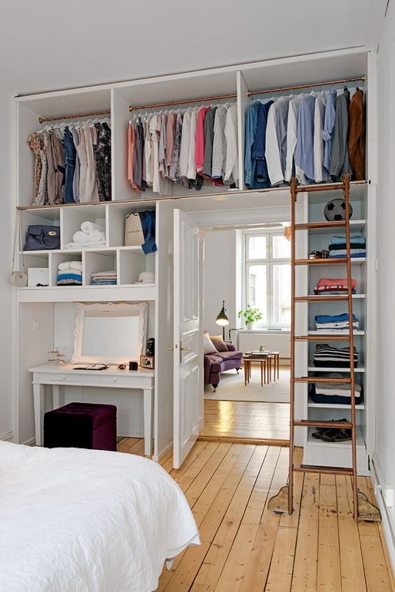 ceiling storage compartments for clothes and a ladder to get them