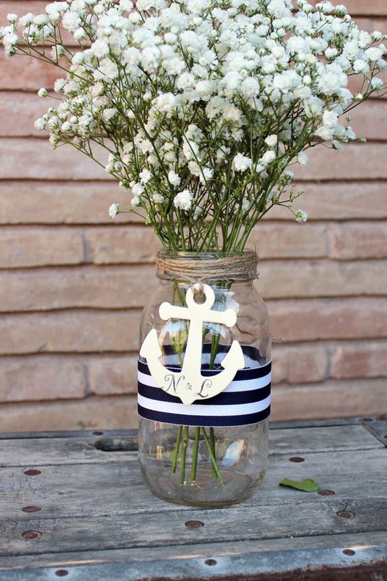 make an easy nautical centerpiece of a mason jar, twine, nautical ribbon and an anchor
