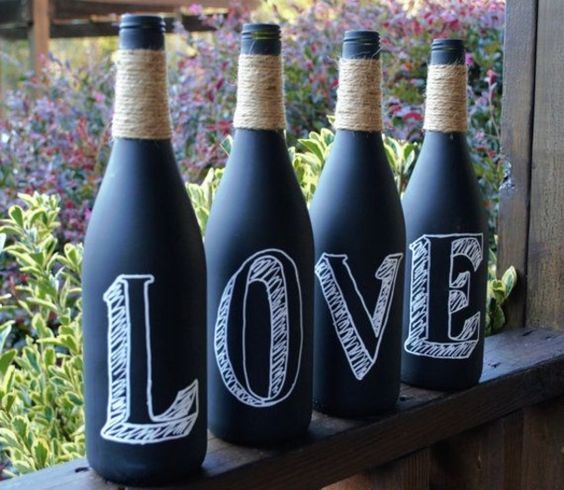 chalkboard wine bottles wrapped with yarn and with letters