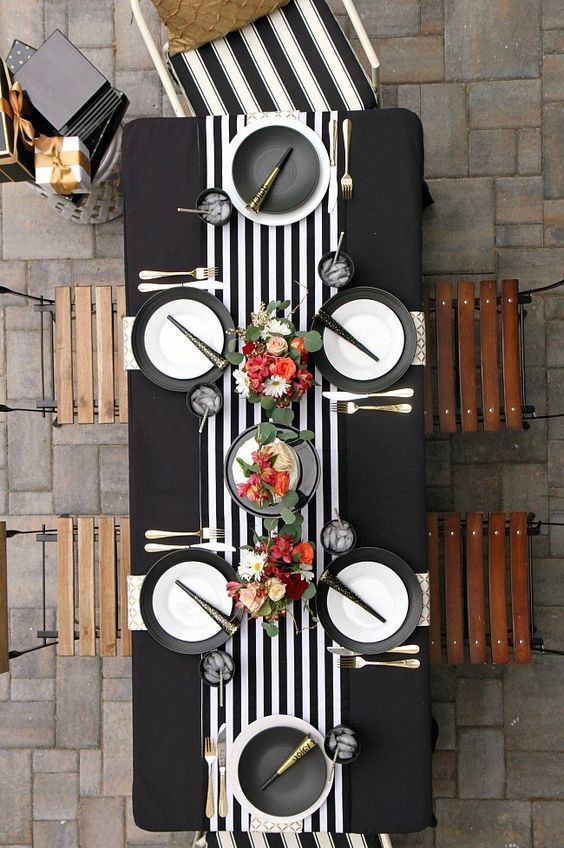 monochrome table decor  (great for Christmas dinner) with bold flowers to enliven it