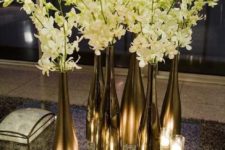 14 metallic wine bottles and white flowers for an elegant centerpiece