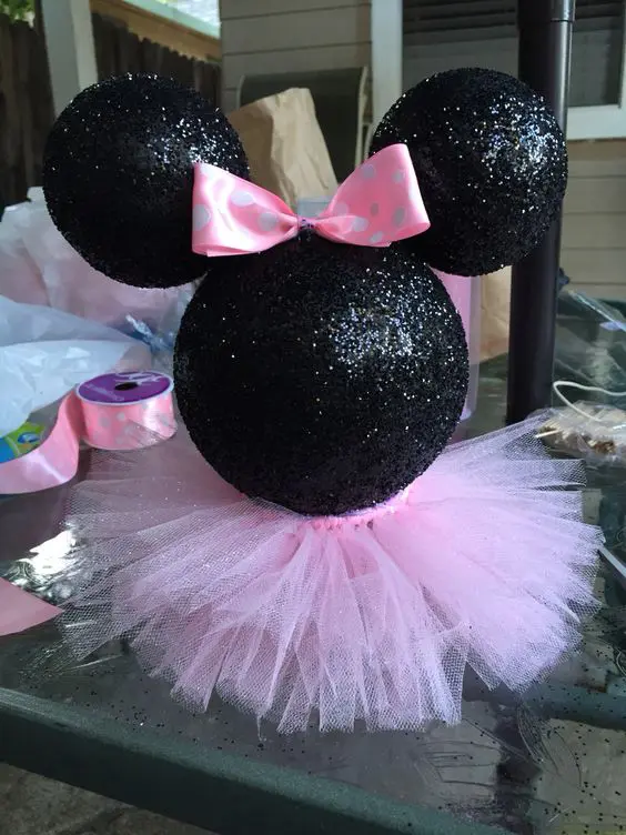 Minnie Mouse styrofoam head painted black and glittered with a pink tutu skirt