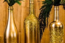 18 gold and glitter bottles with fern and evergreen branches