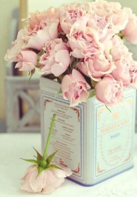 vintage tin can as a vase for blush flowers