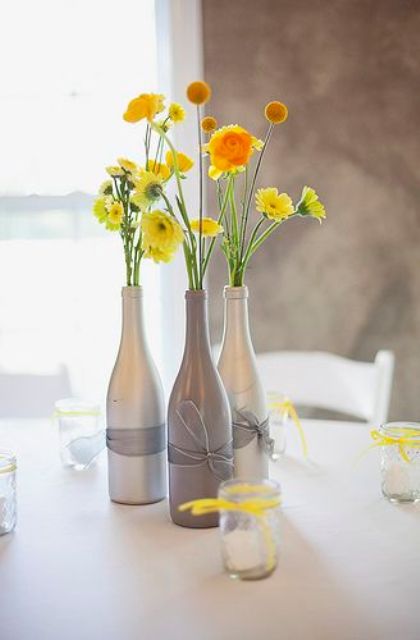 simple beautiful wine bottle centerpieces with ribbon and bold yellow flowers