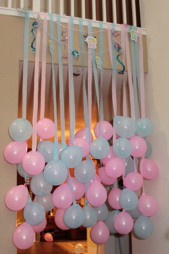 pink and blue balloons hanging from above is an easy way to decorate