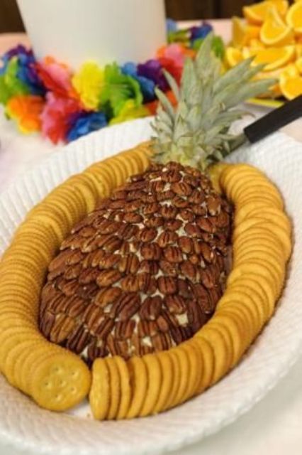 pineapple dip covered with pecans and surrounded by cookies