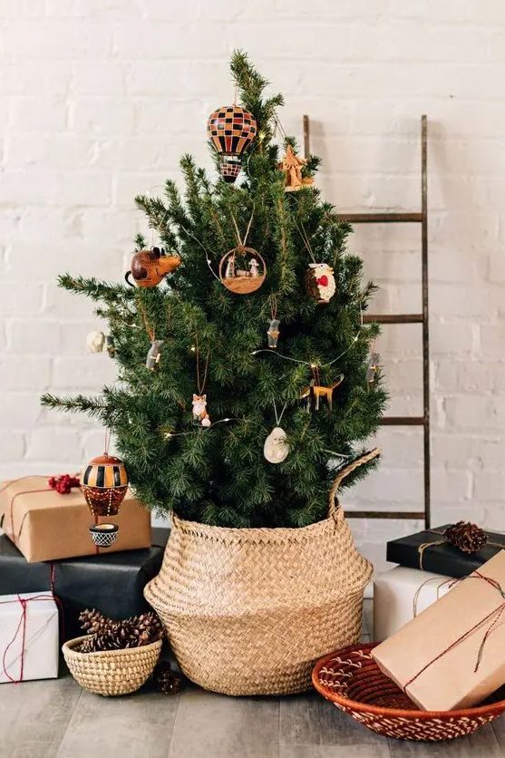 a Christmas tree with little whimsical ornaments and some lights is a cool idea for a modern space