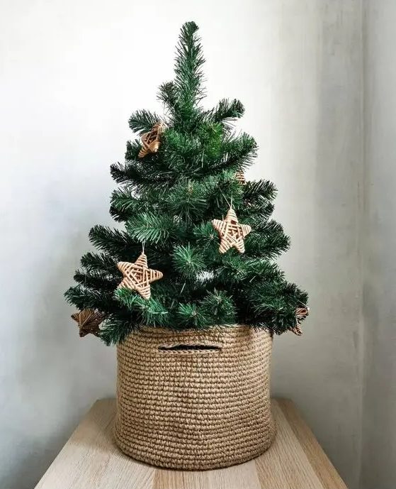a small Christmas tree in a basket, with twine stars, is a lovely rustic decor idea