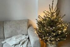 a small Christmas tree with only lights and nothing else looks very festive and cool and brings a holiday feel to the space