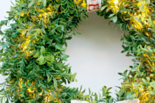 DIY boxwood lit up wreath with a bow
