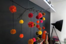 DIY branch and pompom wall decoration