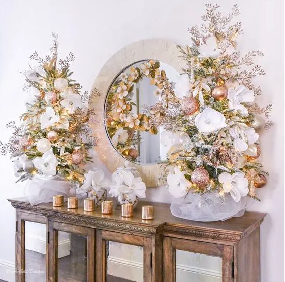 glam tabletop Christmas trees decorated with blush and pearl ornaments, with white fabric blooms and lights look very glam
