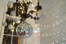 02 hang disco balls on a usual chandlier to cheer up the space