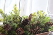 05 a dough bowl with evergreens and pinecones for a rustic look