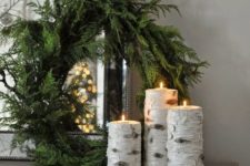 05 candles wrapped with birch bark and a simpel evergreen wreath