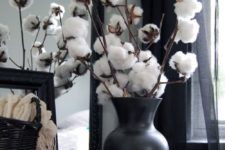 05 cotton balls arrangement in a black vase for a contrast