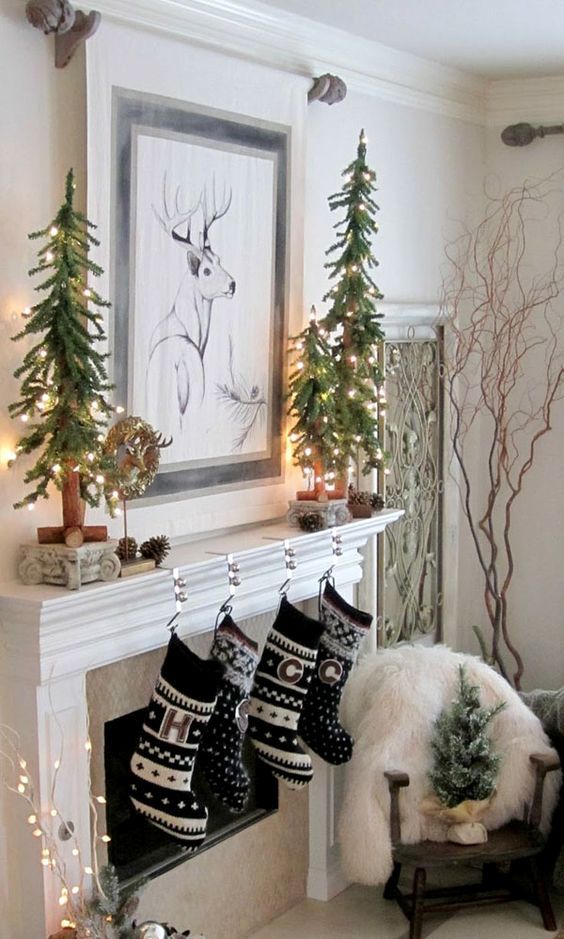 Christmas mantel with stockings, trees and pinecones