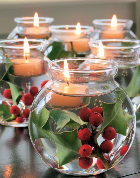 make cool centerpiece of jars with floating candles and holly sprigs