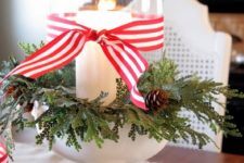 09 a candle jar wrapped with faux greenery, pinecones and striped ribbon