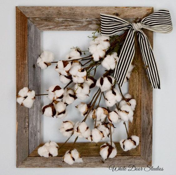 a rustic frame with cotton and a striped bow
