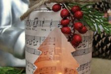 10 a candle lantern with music paper, faux berries and evegreens