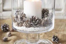 12 a large glass with snowy pinecones and a candle