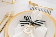 12 black and white table setting is spruced up with gold and glitter touches