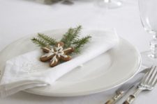 13 white Christmas table with gingerbread cookies and evergrene sprigs